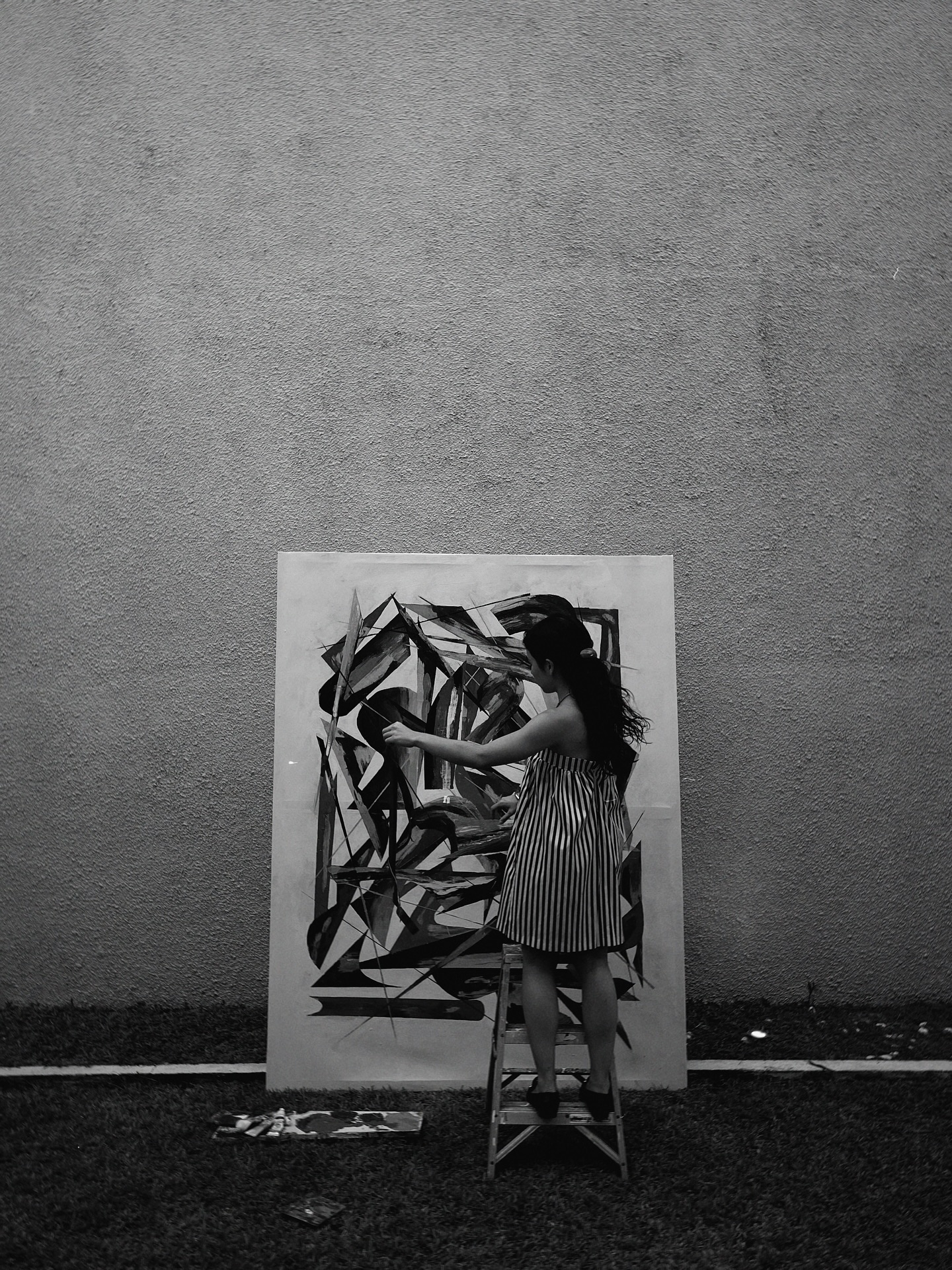 Close-up of a vibrant abstract painting with intersecting lines and colors.